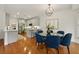 Bright kitchen and dining area featuring hardwood floors, stainless steel appliances, and a modern light fixture at 6355 Glen Oaks Ln, Atlanta, GA 30328