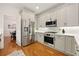 Modern kitchen with stainless steel appliances and white countertops; next to an elegant dining area at 6355 Glen Oaks Ln, Atlanta, GA 30328