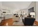 Open-concept living room with fireplace, hardwood floors, and ample seating at 6355 Glen Oaks Ln, Atlanta, GA 30328