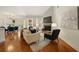 Bright living room featuring hardwood floors, fireplace, and dining area at 6355 Glen Oaks Ln, Atlanta, GA 30328