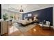 Main bedroom with accent wall, tray ceiling, and herringbone wallpaper at 6355 Glen Oaks Ln, Atlanta, GA 30328