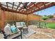 Cozy backyard patio with stylish outdoor furniture and a covered pergola, creating an inviting outdoor space at 6355 Glen Oaks Ln, Atlanta, GA 30328