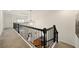 Upstairs hallway features a black iron railing overlooking the hardwood floors and foyer below at 6355 Glen Oaks Ln, Atlanta, GA 30328