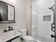 Charming bathroom featuring a brick accent wall, sleek black fixtures, and a modern walk-in shower at 650 Jones Rd, Roswell, GA 30075