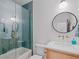 Bright bathroom featuring modern vanity, large shower/tub combo with glass doors and sleek fixtures at 650 Jones Rd, Roswell, GA 30075