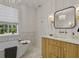 Elegant bathroom featuring a freestanding tub, decorative vanity, and chic lighting fixtures at 650 Jones Rd, Roswell, GA 30075