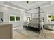 Spacious bedroom with a cozy bed, tray ceiling, and lots of natural light from multiple windows at 650 Jones Rd, Roswell, GA 30075