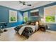 Stylish blue bedroom with a comfortable bed, contemporary artwork, and abundant natural light at 650 Jones Rd, Roswell, GA 30075