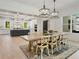 Open-concept dining area with hardwood floors, designer lighting, and seamless flow into a modern kitchen space at 650 Jones Rd, Roswell, GA 30075