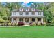 Charming two-story home with a welcoming front porch, lush lawn, and mature trees in a desirable neighborhood at 650 Jones Rd, Roswell, GA 30075
