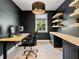 Modern home office with floating shelves, a large window, and adjustable height desk at 650 Jones Rd, Roswell, GA 30075