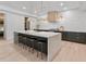 Bright kitchen with a large marble island, pendant lighting, and stainless steel appliances at 650 Jones Rd, Roswell, GA 30075