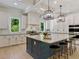Modern kitchen featuring a large island, stainless steel appliances, stylish pendant lighting, and ample cabinet space at 650 Jones Rd, Roswell, GA 30075