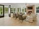 Inviting living room with a brick fireplace, hardwood floors, comfortable seating, and access to an outdoor space at 650 Jones Rd, Roswell, GA 30075