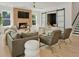 Cozy living room with a brick fireplace, hardwood floors, comfortable seating, and stylish decor for relaxing or entertaining at 650 Jones Rd, Roswell, GA 30075