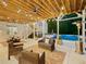 Relaxing outdoor patio area with string lights, comfortable seating, and a view of the pool at 650 Jones Rd, Roswell, GA 30075