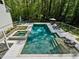 Private backyard oasis featuring a sparkling pool, spa, lounge area, and lush greenery, perfect for entertaining at 650 Jones Rd, Roswell, GA 30075