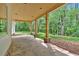 Covered back porch with stone columns and a view of the lush, green backyard at 11 Headden Nw Rdg, Cartersville, GA 30121