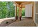 Rear porch featuring wood columns with stone bases and a wooded backyard at 11 Headden Nw Rdg, Cartersville, GA 30121