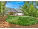 Home exterior with a lush lawn and inviting covered porch area surrounded by trees at 11 Headden Nw Rdg, Cartersville, GA 30121