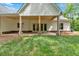 Rear view of a home with a covered back porch and an expansive green yard at 11 Headden Nw Rdg, Cartersville, GA 30121