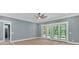 Light-filled bedroom featuring trim, ceiling fan, and french doors to the backyard at 11 Headden Nw Rdg, Cartersville, GA 30121