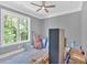 Bedroom with a ceiling fan and backyard view through the bright window at 11 Headden Nw Rdg, Cartersville, GA 30121