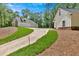 Long driveway leads to a detached garage, with a yard with beautiful landscaping at 11 Headden Nw Rdg, Cartersville, GA 30121