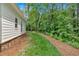 Side view of a home showcasing lush landscaping and a well-maintained lawn at 11 Headden Nw Rdg, Cartersville, GA 30121