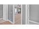 Hallway leading to the living room with natural wood accents and neutral gray walls at 11 Headden Nw Rdg, Cartersville, GA 30121