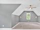 Attic room with neutral walls, a window providing natural light, and a modern ceiling fan at 11 Headden Nw Rdg, Cartersville, GA 30121