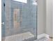 Modern shower with blue tiles, glass door, and sleek fixtures at 11 Headden Nw Rdg, Cartersville, GA 30121