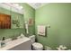 Well-lit half bath with a sink, toilet, and ample counter space at 1519 Brookcliff Cir, Marietta, GA 30062