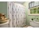 Bathroom area featuring a floral shower curtain and nearby window at 1519 Brookcliff Cir, Marietta, GA 30062