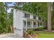 Charming two-story home with a welcoming front porch and attached garage nestled among mature trees at 1519 Brookcliff Cir, Marietta, GA 30062