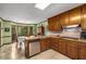 Kitchen boasts wooden cabinets, stainless steel dishwasher, and a cozy breakfast nook with backyard views at 1519 Brookcliff Cir, Marietta, GA 30062