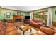 Cozy living room with a fireplace, comfortable seating, and large windows overlooking the backyard at 1519 Brookcliff Cir, Marietta, GA 30062