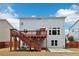 A fenced backyard featuring a wooden deck with stairs and a small concrete patio area at 3750 Thackary Dr, Powder Springs, GA 30127
