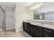 Bathroom with double vanity, large mirror, and walk-in shower at 3750 Thackary Dr, Powder Springs, GA 30127