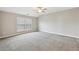 Spacious bedroom with neutral walls, carpet flooring, ceiling fan and a window at 3750 Thackary Dr, Powder Springs, GA 30127