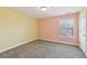 Bedroom featuring colorful yellow and peach walls, carpet flooring, and a window at 3750 Thackary Dr, Powder Springs, GA 30127