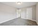Bedroom displaying neutral walls, carpet flooring, and two entry doorways at 3750 Thackary Dr, Powder Springs, GA 30127