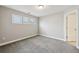 Cozy bedroom featuring three windows for natural light and soft carpet at 3750 Thackary Dr, Powder Springs, GA 30127