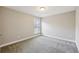 Bedroom highlighting neutral walls, carpet flooring, and a window with blinds at 3750 Thackary Dr, Powder Springs, GA 30127