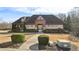 Community clubhouse with brick and stone accents, surrounded by manicured landscaping at 3750 Thackary Dr, Powder Springs, GA 30127
