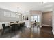 Formal dining room with hardwood flooring, wainscoting, a chandelier, and an adjacent office space at 3750 Thackary Dr, Powder Springs, GA 30127