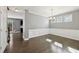 Dining room with wood floors, wainscoting, and three large windows with natural light at 3750 Thackary Dr, Powder Springs, GA 30127