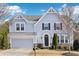 Charming two-story home features a two-car garage, stone accents, a dark door, and classic architectural details at 3750 Thackary Dr, Powder Springs, GA 30127