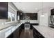 Kitchen features dark cabinets, granite countertops, stainless steel appliances, and natural light at 3750 Thackary Dr, Powder Springs, GA 30127