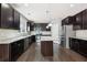 Modern kitchen featuring dark cabinets, granite countertops, stainless steel appliances and kitchen island at 3750 Thackary Dr, Powder Springs, GA 30127
